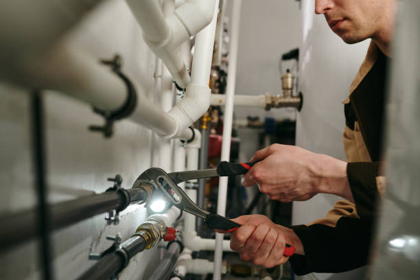 Technician performing precision work on mechanical equipment